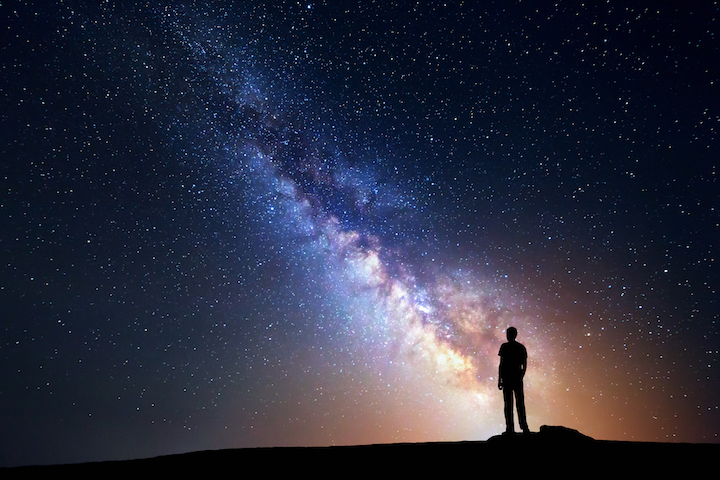 Milky Way. Night sky and silhouette of a standing man